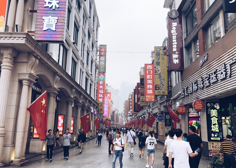 People walking along Guangzhou’s Shangxiajiu Pedestrian Street.